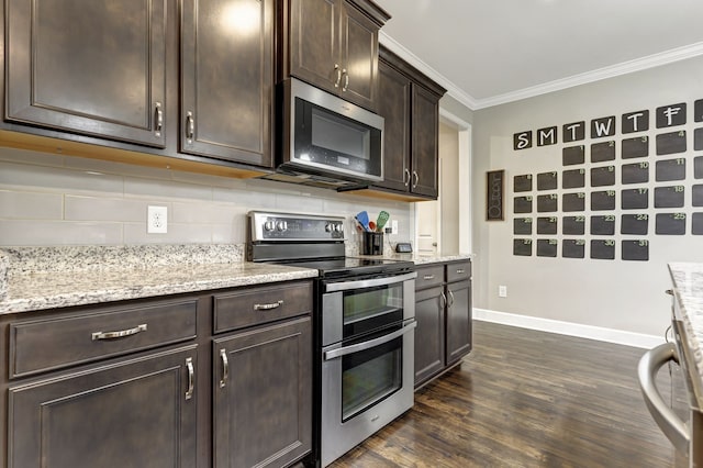 kitchen featuring light stone countertops, stainless steel appliances, dark brown cabinetry, dark wood-type flooring, and ornamental molding