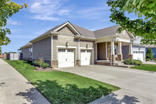 craftsman house with a front yard and a garage