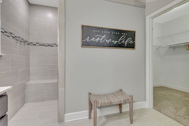 bathroom with vanity, tile patterned floors, and tiled shower