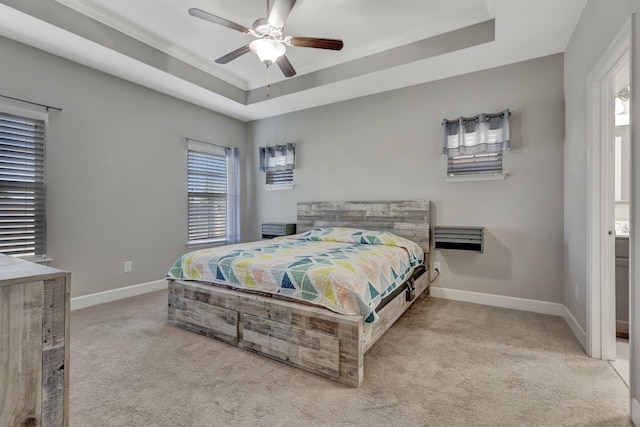 carpeted bedroom featuring ceiling fan, a raised ceiling, and multiple windows