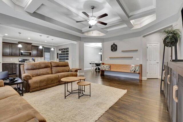 living room featuring ceiling fan, ornamental molding, dark hardwood / wood-style floors, beamed ceiling, and coffered ceiling