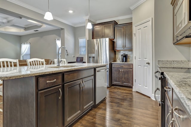 kitchen with sink, a kitchen breakfast bar, coffered ceiling, stainless steel appliances, and pendant lighting