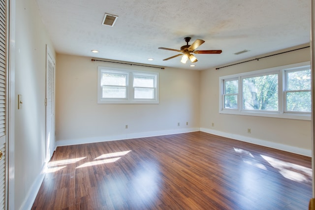 empty room featuring a textured ceiling, wood-type flooring, and ceiling fan