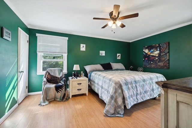 bedroom with ceiling fan, crown molding, and light hardwood / wood-style flooring