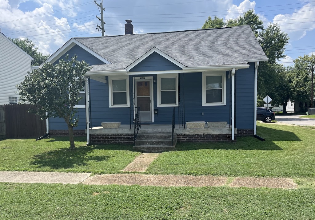 bungalow-style home with a front lawn