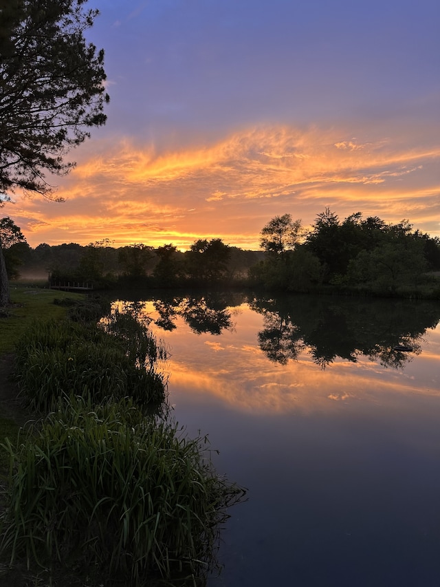 nature at dusk featuring a water view