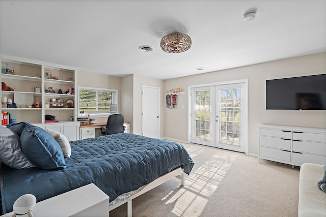 bedroom with multiple windows, french doors, access to exterior, and light colored carpet