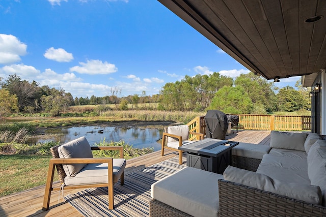 wooden deck featuring a water view, area for grilling, and outdoor lounge area