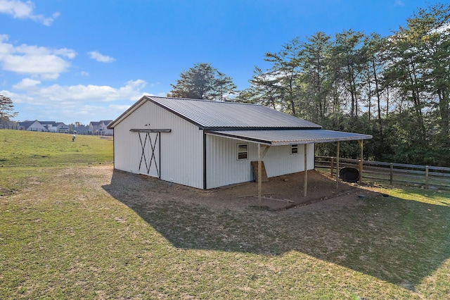 view of outbuilding with a lawn