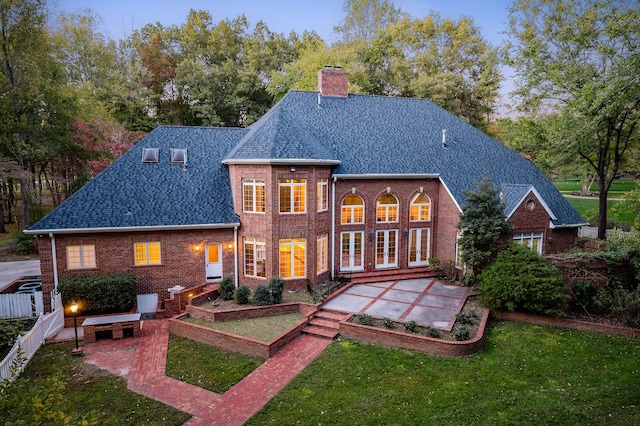 rear view of property featuring french doors, a yard, and a patio area