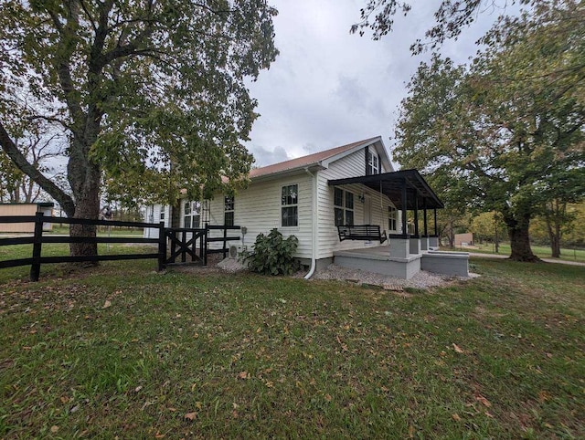 view of side of property with a yard