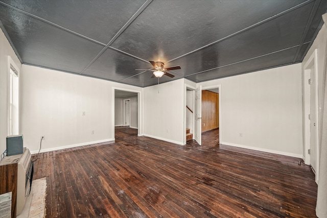 unfurnished living room featuring ceiling fan and dark hardwood / wood-style flooring