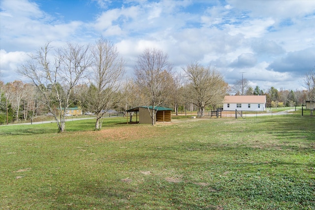 view of yard featuring an outdoor structure and a rural view