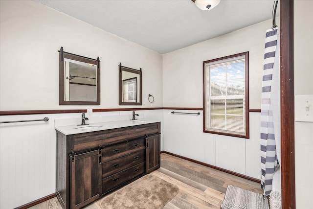 bathroom featuring vanity, a textured ceiling, and wood-type flooring