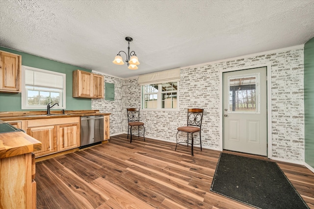 kitchen featuring dark hardwood / wood-style flooring, a chandelier, dishwasher, butcher block counters, and pendant lighting