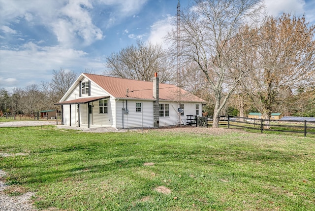 back of house with a patio area and a yard