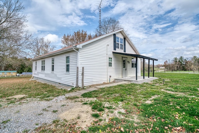 back of property with a lawn