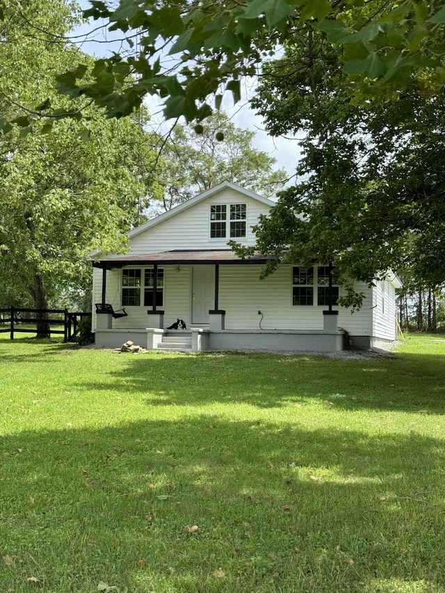 view of front of home featuring covered porch and a front yard