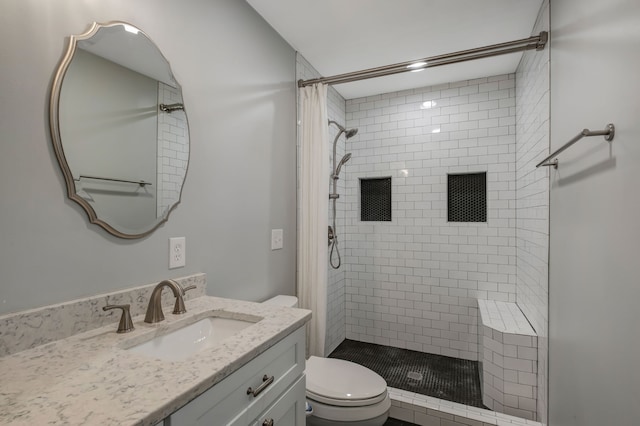 bathroom with vanity, toilet, and curtained shower