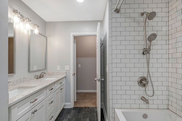 bathroom featuring vanity, tiled shower / bath combo, and tile patterned flooring