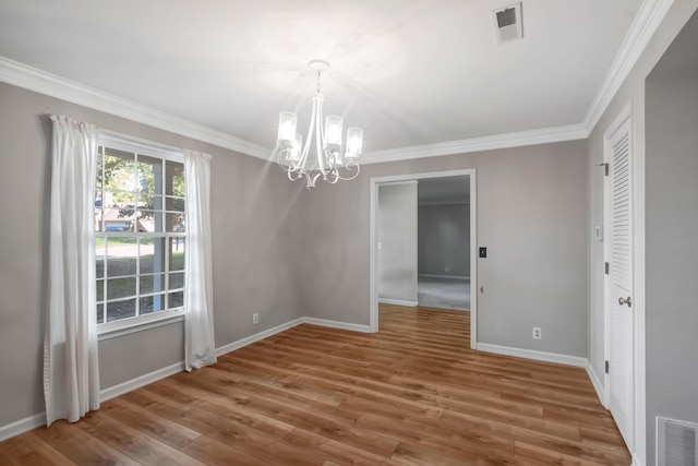 unfurnished dining area with a notable chandelier, hardwood / wood-style flooring, and ornamental molding