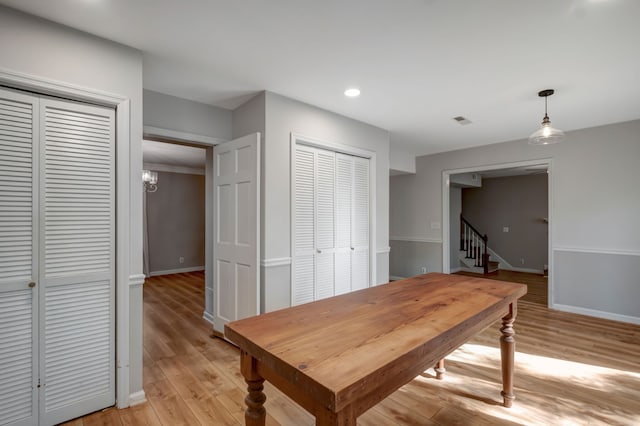 dining area featuring light hardwood / wood-style floors and an inviting chandelier