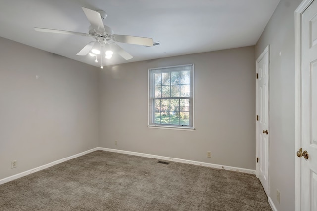 carpeted spare room featuring ceiling fan