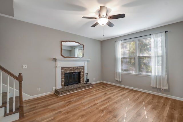 unfurnished living room with light hardwood / wood-style flooring, a fireplace, and ceiling fan