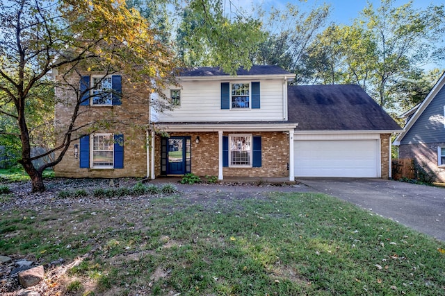 view of front of property with a front yard and a garage