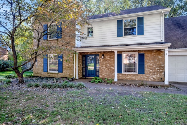 view of front of property with a front lawn and a garage