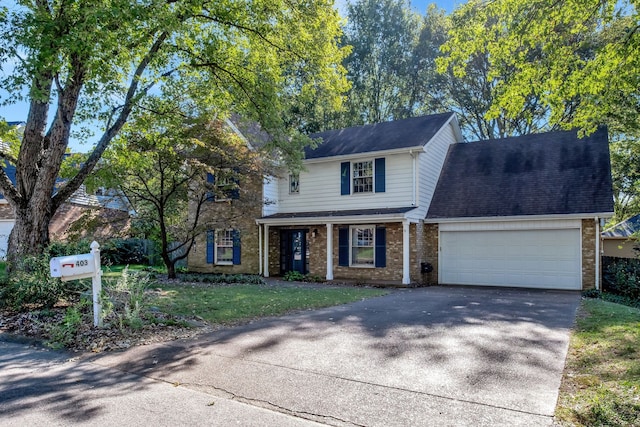 view of front of home featuring a front yard and a garage