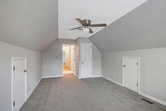 additional living space with light carpet, ceiling fan, and vaulted ceiling