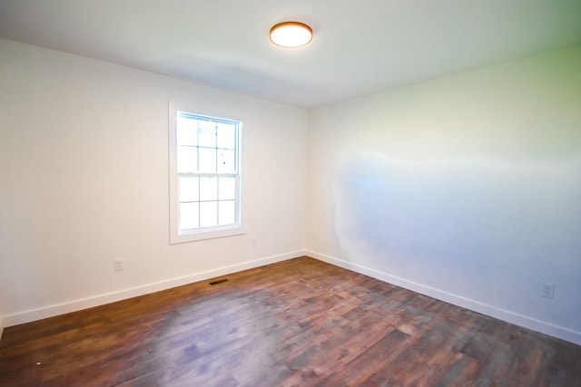 spare room featuring dark hardwood / wood-style flooring