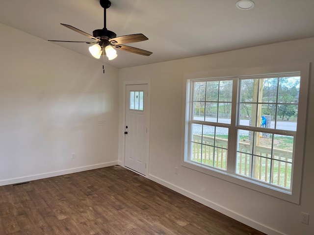 entrance foyer featuring a wealth of natural light, dark hardwood / wood-style flooring, and ceiling fan