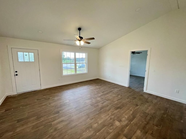 empty room featuring ceiling fan, dark wood-type flooring, and vaulted ceiling