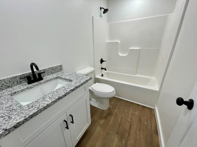 full bathroom with vanity, toilet, wood-type flooring, and bathtub / shower combination