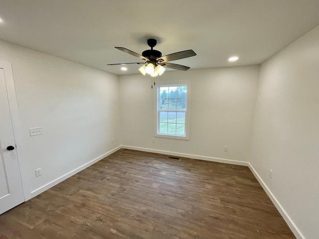 unfurnished room featuring dark hardwood / wood-style flooring and ceiling fan