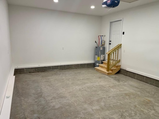 garage featuring electric water heater and a garage door opener