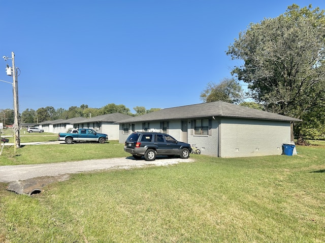 view of side of property with a lawn