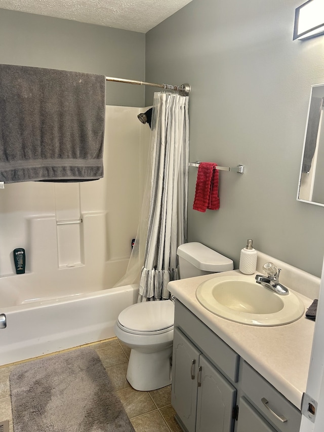 full bathroom featuring a textured ceiling, toilet, vanity, shower / tub combo with curtain, and tile patterned flooring