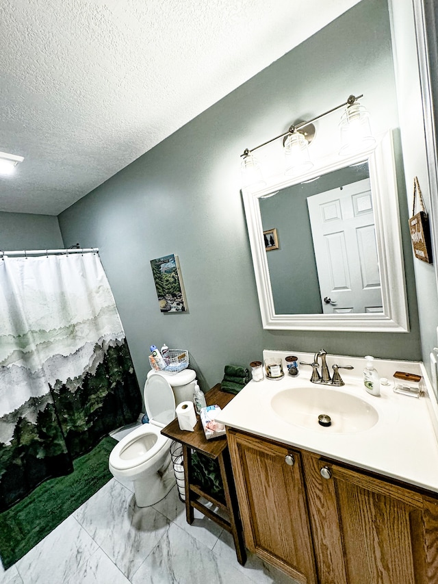 bathroom with vanity, a shower with curtain, a textured ceiling, and toilet