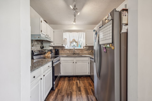 kitchen featuring appliances with stainless steel finishes, sink, backsplash, white cabinetry, and dark hardwood / wood-style floors