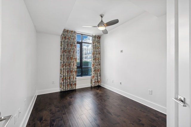 spare room featuring ceiling fan and dark hardwood / wood-style flooring