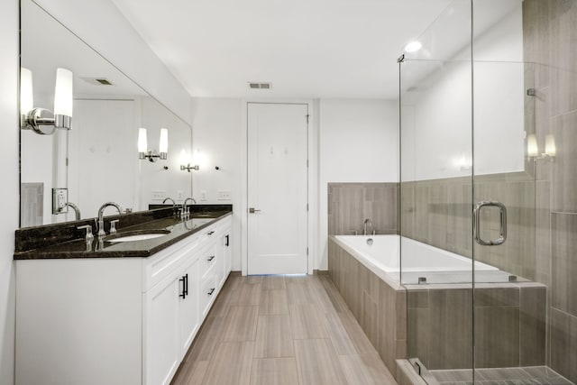 bathroom with vanity and plus walk in shower