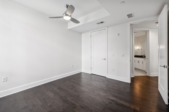 unfurnished bedroom with a closet, dark wood-type flooring, and ceiling fan