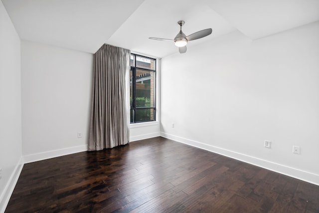 empty room featuring ceiling fan and dark hardwood / wood-style flooring