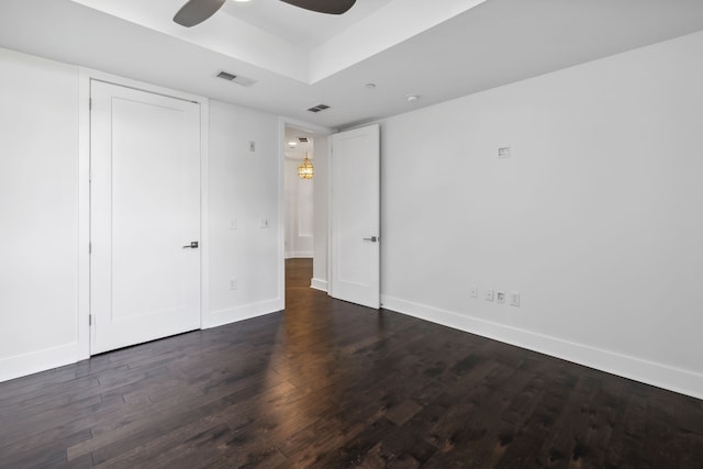 unfurnished bedroom featuring dark hardwood / wood-style floors and ceiling fan