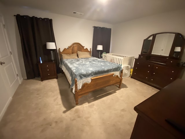 bedroom with light colored carpet