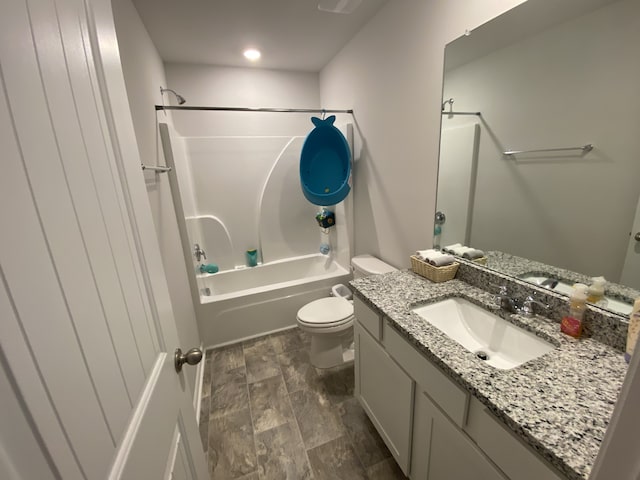 full bathroom featuring vanity, bathtub / shower combination, hardwood / wood-style floors, and toilet