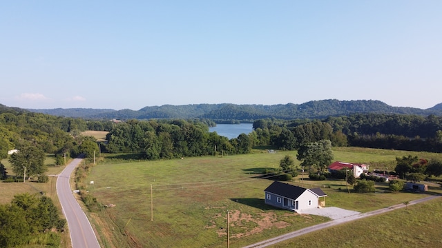 drone / aerial view featuring a rural view and a water and mountain view